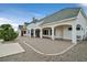 Rear exterior elevation featuring a covered patio, desert landscaping, and white siding at 156 N Parawan St, Henderson, NV 89015