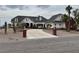Stately home featuring a brick-lined driveway leading to a portico entrance and a well-manicured, xeriscaped front yard at 156 N Parawan St, Henderson, NV 89015