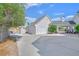 Spacious garage and large driveway with a carport area that adds charm and function to the home at 156 N Parawan St, Henderson, NV 89015
