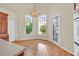 Bright kitchen nook with wood floors, chandelier, and large windows at 156 N Parawan St, Henderson, NV 89015