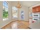 Bright kitchen nook featuring wood floors, a chandelier, and large windows at 156 N Parawan St, Henderson, NV 89015