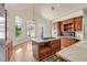 Well-lit kitchen with island, wood cabinets, and modern appliances at 156 N Parawan St, Henderson, NV 89015