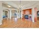 Open-concept living room boasting hardwood floors, a cozy fireplace, and an antler chandelier, radiating elegance at 156 N Parawan St, Henderson, NV 89015