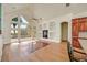 Living room with vaulted ceiling, large windows, and built-in shelves at 156 N Parawan St, Henderson, NV 89015