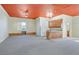 Open concept living room with a kitchenette and windows that provide natural light inside of home at 156 N Parawan St, Henderson, NV 89015