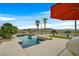 Inviting pool with desert landscaping, an umbrella-shaded lounge area, and mountain views at 156 N Parawan St, Henderson, NV 89015