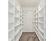 Walk-in closet with custom shelving units to maximize storage space inside of the home at 156 N Parawan St, Henderson, NV 89015