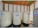 Close up of the water tanks in a caged area outside of the home at 156 N Parawan St, Henderson, NV 89015