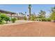 Expansive backyard with desert landscaping, patio and tall palm trees at 1970 Del Font Ct, Las Vegas, NV 89117