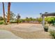 View of the backyard basketball court, desert landscaping and tall palm trees at 1970 Del Font Ct, Las Vegas, NV 89117