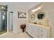 Primary bathroom featuring dual vanity sinks, custom tile work and walk-in shower at 1970 Del Font Ct, Las Vegas, NV 89117
