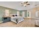 Spacious bedroom with wood floors, natural light, ceiling fan and modern furnishings at 1970 Del Font Ct, Las Vegas, NV 89117