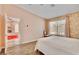Bright bedroom with wood floors and a view of a fireplace and stone wall at 1970 Del Font Ct, Las Vegas, NV 89117