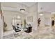 Bright dining room features chandelier, large window and modern glass table and chairs at 1970 Del Font Ct, Las Vegas, NV 89117