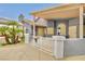 Landscaped front yard with palm trees and stucco home, including covered porch and ornate courtyard gates at 1970 Del Font Ct, Las Vegas, NV 89117
