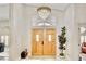Grand foyer with a soaring ceiling, elegant chandelier, and beautiful double doors at 1970 Del Font Ct, Las Vegas, NV 89117
