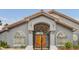 Elegant front entrance with decorative iron gate, wooden double doors, and manicured landscaping at 1970 Del Font Ct, Las Vegas, NV 89117