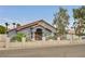 Charming single-story home showcasing a decorative iron gate, tile roof, and manicured landscaping at 1970 Del Font Ct, Las Vegas, NV 89117