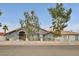 Charming single-story home showcasing a decorative iron gate, tile roof, and manicured landscaping at 1970 Del Font Ct, Las Vegas, NV 89117