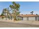 Charming single-story home with three-car garage, decorative iron gate, tile roof, and mature trees at 1970 Del Font Ct, Las Vegas, NV 89117