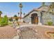 Inviting front yard with bridge over dry creek bed, desert landscaping, and gray stucco exterior at 1970 Del Font Ct, Las Vegas, NV 89117