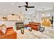 Bright living room featuring marble floors, a ceiling fan, and seamlessly connects to the kitchen and dining area at 1970 Del Font Ct, Las Vegas, NV 89117