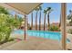 This backyard features a sparkling pool and mature palm trees at 1970 Del Font Ct, Las Vegas, NV 89117