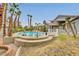 This backyard features a pool and spa surrounded by palm trees at 1970 Del Font Ct, Las Vegas, NV 89117