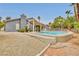 Inviting pool with a covered patio, surrounded by desert landscaping at 1970 Del Font Ct, Las Vegas, NV 89117