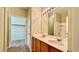 Bright bathroom featuring double sinks, vanity with wood cabinets, and a shower over bath at 2000 Gravel Hill St # 203, Las Vegas, NV 89117