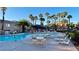 Large community pool with lounge chairs, tables, umbrellas and palm trees at 2000 Gravel Hill St # 203, Las Vegas, NV 89117