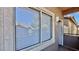 Exterior shot showing window and door entrance to a condo unit, with a metal railing at 2000 Gravel Hill St # 203, Las Vegas, NV 89117