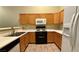 This kitchen features wooden cabinets, white countertops, stainless steel sink and modern appliances at 2000 Gravel Hill St # 203, Las Vegas, NV 89117