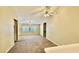Open-concept living area featuring carpet, neutral tones, fan and natural light at 2000 Gravel Hill St # 203, Las Vegas, NV 89117