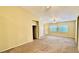 Open-concept living area featuring carpet, neutral tones, fan and natural light at 2000 Gravel Hill St # 203, Las Vegas, NV 89117