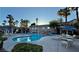 Resort-style pool with palm trees and lounge chairs for relaxing in the sun with a beautiful apartment complex backdrop at 2000 Gravel Hill St # 203, Las Vegas, NV 89117
