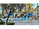 Community pool area features lounge chairs, tables, and large umbrellas at 2000 Gravel Hill St # 203, Las Vegas, NV 89117