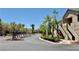Apartments line a well-maintained street with mature trees and landscaping at 2000 Gravel Hill St # 203, Las Vegas, NV 89117