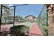 Community tennis court with green fence and surrounding landscaping at 2000 Gravel Hill St # 203, Las Vegas, NV 89117