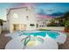 An inviting backyard with a sparkling pool and spa, perfect for outdoor relaxation and entertaining at 2107 Fountain Springs Dr, Henderson, NV 89074