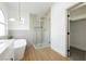 Bright bathroom featuring a modern glass shower and standalone tub, illuminated by stylish lighting at 2107 Fountain Springs Dr, Henderson, NV 89074