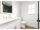Bathroom featuring a white vanity, mirror, and bathtub with dark tile at 2107 Fountain Springs Dr, Henderson, NV 89074