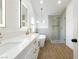 Bright bathroom boasting double vanities, a standalone tub, and a modern glass shower at 2107 Fountain Springs Dr, Henderson, NV 89074