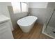 Bright bathroom showcasing a standalone tub next to a glass shower and large window at 2107 Fountain Springs Dr, Henderson, NV 89074