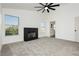 Spacious bedroom featuring a fireplace, ceiling fan, and access to an ensuite bathroom at 2107 Fountain Springs Dr, Henderson, NV 89074