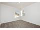 Bright bedroom with plush carpeting and natural light from two corner windows at 2107 Fountain Springs Dr, Henderson, NV 89074