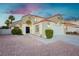 Inviting home showcasing a well-kept front yard with desert landscaping, a two-car garage, and tile roof at 2107 Fountain Springs Dr, Henderson, NV 89074