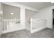 Upstairs landing features neutral carpet and railing, leading to various rooms in this open layout at 2107 Fountain Springs Dr, Henderson, NV 89074