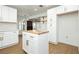 Open-concept kitchen featuring a wood-topped island, white cabinetry, and stainless steel appliances at 2107 Fountain Springs Dr, Henderson, NV 89074