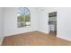 Bright living room with a large arched window and wood-look flooring; light and airy space connects to the kitchen at 2107 Fountain Springs Dr, Henderson, NV 89074